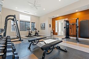 Leavenworth apartment for rent - A spacious home gym with a variety of equipment including a bench press, a squat rack, and a treadmill.