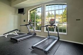 Everett apartment for rent - A gym with treadmills and a wall-mounted speaker.