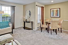 Everett apartment for rent - A bedroom with a bed, chair, and a painting on the wall.