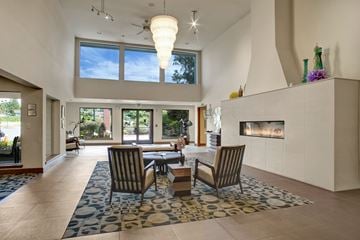 Renton apartment for rent - A modern living room with a fireplace and a dining table set up.