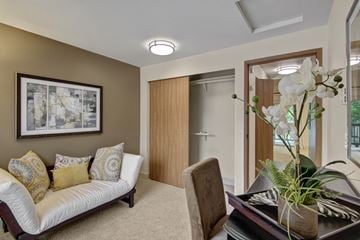 Kent apartment for rent - A living room with a sofa, a chair, and a coffee table with a vase of flowers on it.