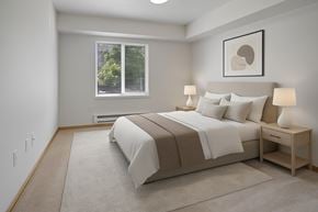 Everett apartment for rent - A bedroom with a large bed and a window with blinds.