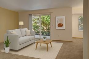 Everett apartment for rent - A living room with a white couch, a wooden coffee table, and a plant.