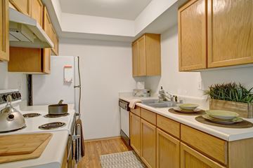 Everett apartment for rent - A kitchen with wooden cabinets and a white refrigerator.