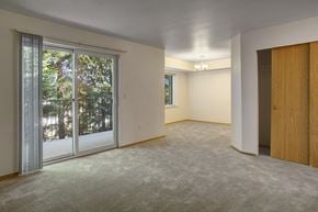 Everett apartment for rent - A room with a sliding glass door and carpeted floor.