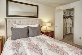 Mountlake Terrace apartment for rent - A bedroom with a large bed and a mirror above it.