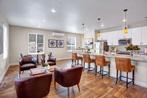 Leavenworth apartment for rent - A kitchen with brown chairs and a white counter.