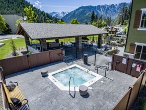 Leavenworth apartment for rent - A hot tub sits in the middle of a patio with a mountain view.
