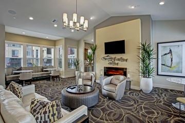 Wenatchee apartment for rent - A living room with a fireplace and a television mounted on the wall.