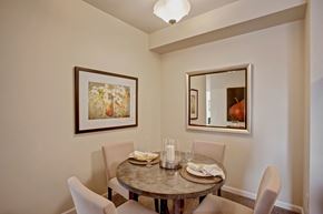 Moses Lake apartment for rent - A charming dining area here at Solara with a round table, comfortable chairs, elegant wall art, and a decorative centerpiece creating a warm, inviting space.