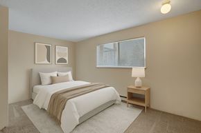 Federal Way apartment for rent - A cozy bedroom here at Soundview with soft carpet, bright window, and staged bed with neutral bedding creating a comfortable and inviting retreat.