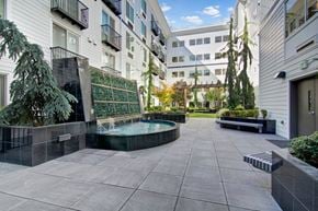 Shoreline apartment for rent - A courtyard with a pool surrounded by buildings.