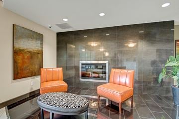 Shoreline apartment for rent - A living room with a painting on the wall and a television.