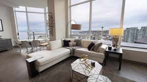 Seattle apartment for rent - A modern living room with a large window overlooking the city.