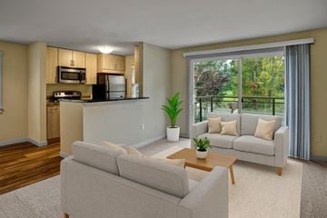 Kenmore apartment for rent - A modern living room with a grey sofa and a coffee table.