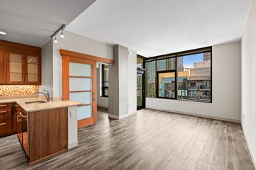 Seattle apartment for rent - A kitchen with wooden cabinets and a countertop with a sink.