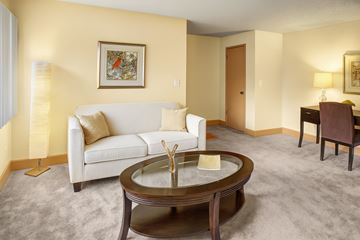 Lynnwood apartment for rent - A living room with a white couch, a coffee table, and a painting on the wall.