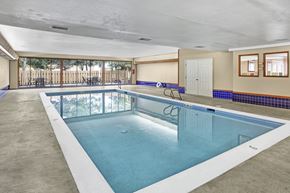 Lynnwood apartment for rent - A large indoor swimming pool with a glass divider.