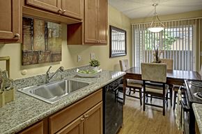 Lynnwood apartment for rent - A kitchen with wooden cabinets and granite countertops.