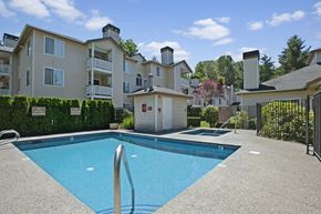 Issaquah apartment for rent - A sparkling outdoor pool here at Windsong surrounded by charming apartment buildings and lush greenery. This bright and inviting space offers clear blue water, a relaxing hot tub, and a peaceful setting perfect for enjoying sunny days.