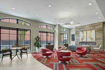 Woodinville apartment for rent - A living room with a red rug and red chairs.