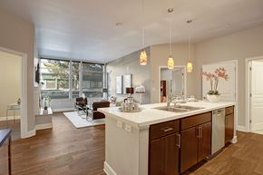 Woodinville apartment for rent - A kitchen with a white counter top and wooden cabinets.