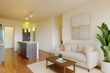 Milwaukee apartment for rent - A living room with a white couch and a wooden coffee table.