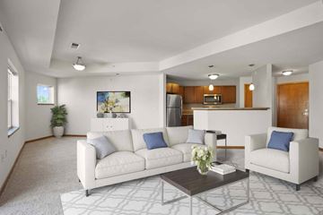 Madison apartment for rent - A living room with a white couch, a coffee table, and a painting on the wall.