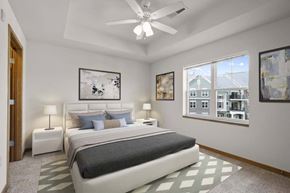 Madison apartment for rent - A bedroom with a large bed and a ceiling fan.