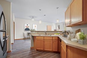 Madison apartment for rent - A kitchen with wooden cabinets and a white counter.