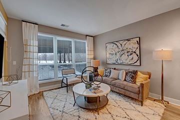 Milwaukee apartment for rent - A living room with a couch, a coffee table, and a painting on the wall.
