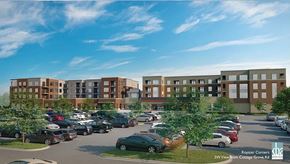 Madison apartment for rent - A modern exterior community view here at Royster Commons with stylish buildings, large windows, and landscaped surroundings. A welcoming design and spacious parking area create an attractive and vibrant atmosphere.