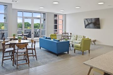Madison apartment for rent - A living room with a blue sofa and a television on the wall.