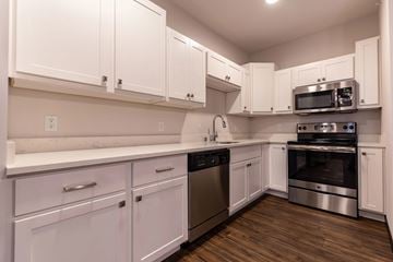Deforest apartment for rent - A kitchen with white cabinets and stainless steel appliances.