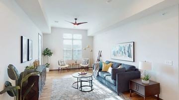 Sun Prairie apartment for rent - A living room with a grey couch, a coffee table, and a painting on the wall.