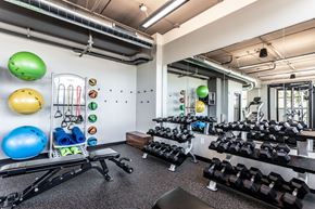 Milwaukee apartment for rent - A gym with a variety of equipment including dumbbells, exercise balls, and resistance bands.