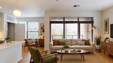Milwaukee apartment for rent - A living room with a white couch and a coffee table.