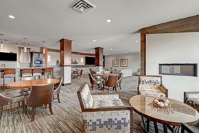 Fitchburg apartment for rent - A modern dining room here at Vue at Pinnacle Park with a wooden table and chairs.