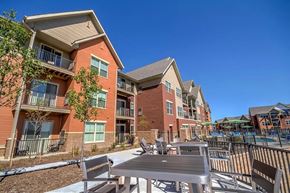 Fitchburg apartment for rent - A sunny day at a residential complex here at Vue at Pinnacle Park with a pool and outdoor furniture.