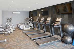 Fitchburg apartment for rent - A gym here at Vue at Pinnacle Park with treadmills, exercise bikes, and other equipment.