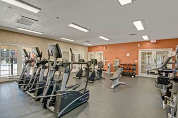 A gym with cardio and strength training equipment