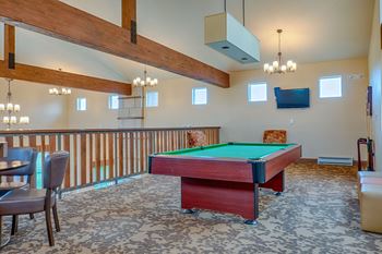 Resident game room with pool table and plenty of seating