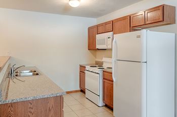 White appliances and granite countertops