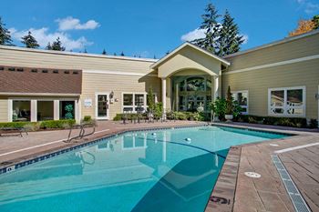 Outdoor pool with lounge chairs on the patio