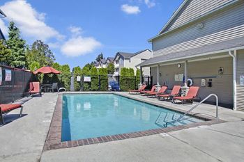 Outdoor pool surrounded by lounge chairs