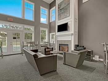 Arbor ridge common area with couches, fireplace, and view