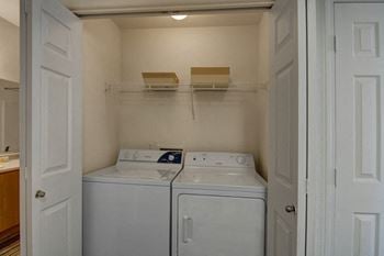 Arezzo apartments- large wash room with storage space 