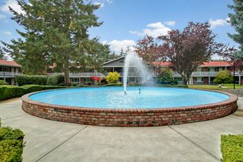 Colonial square's well-maintained landscaping and fountain