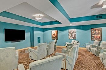 Covington media room with tv and lounge chairs