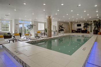 Indoor pool with lounge chairs and couches